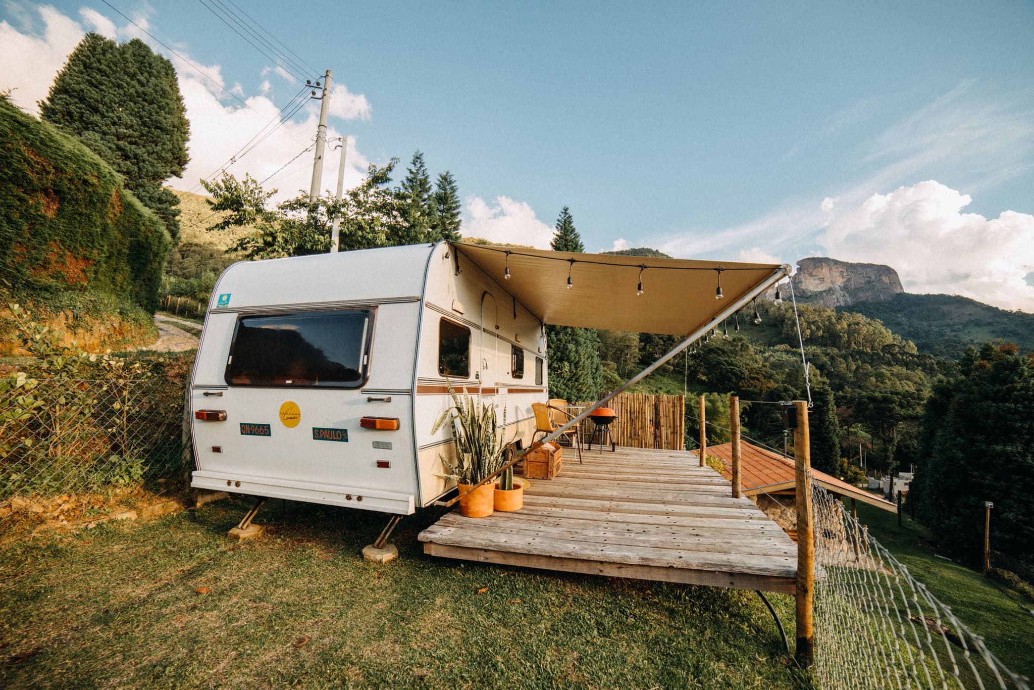A camper trailer parked in the mountains