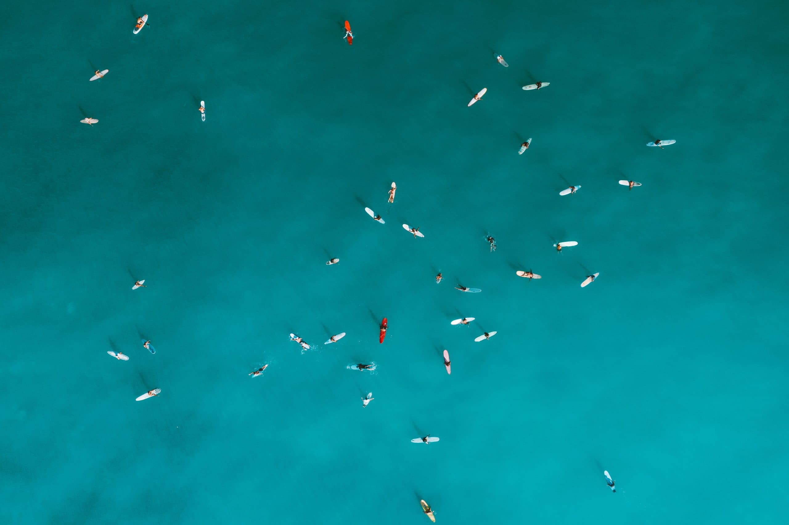 Boats scattered across turquoise water, seen from above