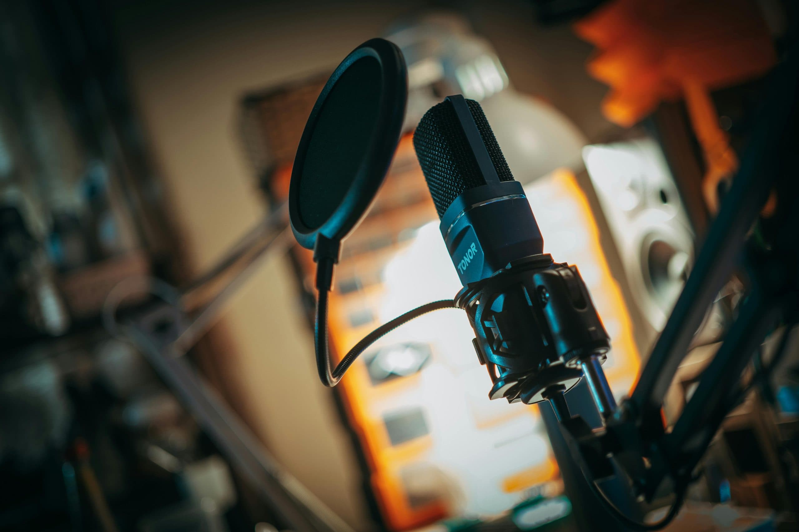 A studio microphone in warm low light